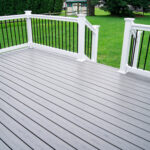 Composite gray deck with white composite handrail and black pickets